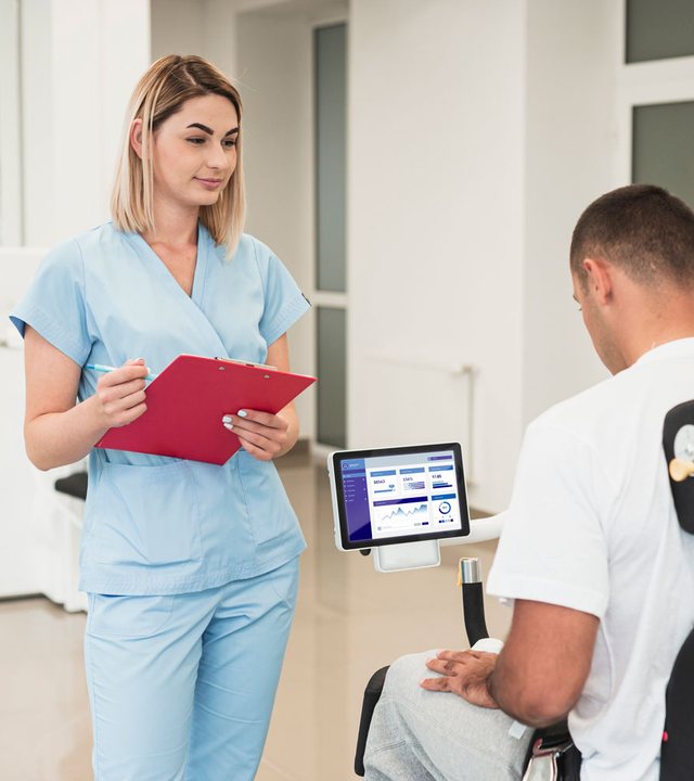 Nurse supporting a patient during rehabilitation